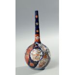 A Japanese Meiji period Imari vase of bulbous form with a tall slender neck, decorated in typical