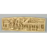 A Japanese Meiji period relief carved ivory wrist rest, with figures in a village setting, 5w.