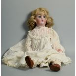 An early 20c Simon & Halbig girl doll with bisque head, composite articulated body, open mouth and