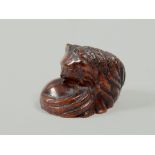 A Japanese Meiji period amber netsuke carved as a seated cat, base signed.