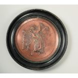 .A Victorian copper circular plaque, embossed and chased with an angel and a baby holding a cornet