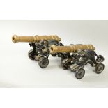 A pair of late Victorian/Edwardian ornamental cannons with mythical beast cast four wheeled