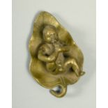 A 19c bronze of a boy baby playing with his toes, lying on a lillypad, 3w.