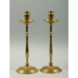 A pair of 19c tall baluster candlesticks with circular step bases, wide drip pans and fixed sockets,