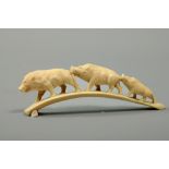 A Japanese Meiji period carving of a trail of three wild boar, signed, 6.25l.