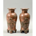 A pair of Japanese Meiji period coppered alloy baluster vases decorated in relief with Samurai