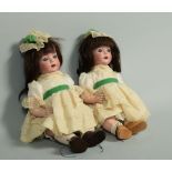 A pair of early 20c Schoenau & Hoffmeister twin girl dolls, 'Hannah' with bisque heads and composite