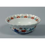 A 17c/18c Japanese Kakiemon dish with scalloped border, floral decorated, 6.25diam.