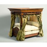 A late 19c/early 20c mahogany dolls four poster bed, with moulded canopy, baluster carved bed posts,