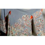 A Japanese blue silk Kimono decorated in wire thread and coloured silks, with islands and turtles,