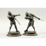 A pair of 19c patinated bronze figures of Japanese Warriors in combat, the oval bases signed E Le