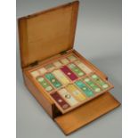 A late 19c fitted box containing one hundred and forty four various prepared microscope slides of