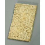 A Japanese Meiji period carved ivory visiting card case, with scenes of figures in village settings,