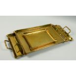 A set of three late Victorian brass galleried trays, two with side handles, copper riveted, 23w, 17w