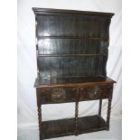 An old carved oak slim dresser with two