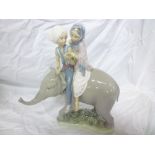 A Lladro china figure of a boy and girl