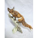 A Continental china figure of a fox on a