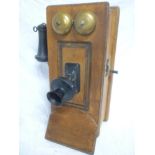 An old wall mounted telephone within oak