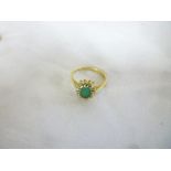 An 18ct gold dress ring set central emer