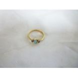 A 9ct gold dress ring set opal flanked b