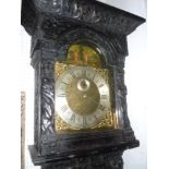 A longcase clock with 13" brass and silv