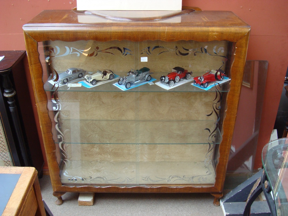A 1950's display cabinet with sliding doors.