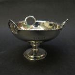 A silver pedestal bon bon dish with three cut away handles with swag detail, Birmingham 1918,