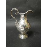 A George Unite silver pedestal milk jug with scroll handle, embossed fruit and flowers,