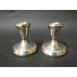 A pair of silver squat filled candlesticks, Birmingham 1988,