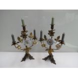 A pair of 19th Century brass and ceramic candle stands, 43.