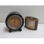 A Jaeger 8 days alarm carriage/desk clock and an ebonised desk clock on bun feet (2)