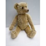A 1920's blonde Mohair German Bing teddy bear with jointed limbs and growler,