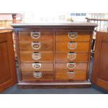 Circa 1920 an "Ambergs Patents Index" mahogany table top filing cabinet the two doors opening to