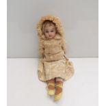 A 13" bisque head girl doll in cream silk outfit,
