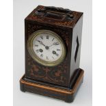 A late 19th Century inlaid and stained wood mantel clock with ornate metal overhead swing handle,