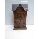 A two storey dolls house of small proportions with grand manor design complete with two figures and