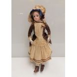 A German dressed doll with bisque head and glass eyes,