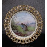 An early 20th Century porcelain ribbon plate with gilded surround,