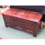 Circa 1740 an oak three panel coffer the hinged lid over a carved front on stile feet