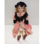 A 30" tall bisque headed girl doll with sleepy eyes and leather legs and feet,