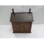 A wooden painted two tier dolls house with furniture