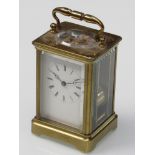A 19th Century French brass carriage clock with Roman enamelled dial (hairlined),
