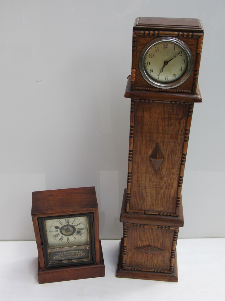 An American mahogany cased alarm clock and an oak cased miniature longcase clock with silvered