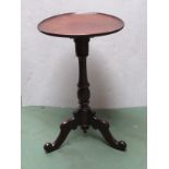 A circa 1840 flame mahogany wine table the circular dished tilt top over a turned column and scroll