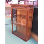 An Edwardian mahogany table top shop display single door cabinet