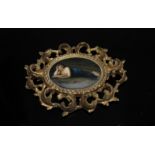 A circa 1900 florentine framed ovoid Dresden porcelain plaque,