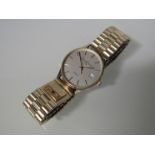 ASPREY & GARRARD: A 9ct gold quartz wristwatch with centre seconds and date aperture,