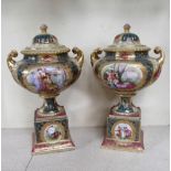 A pair of Vienna porcelain lidded vases, decorated in red and green panels with figural cartouches,