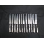 Twelve dinner knives with embossed white metal handles stamped sterling