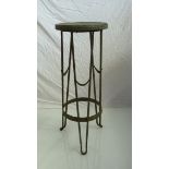 A 19th Century iron jardiniere stand the circular top on outswept supports with swag decoration